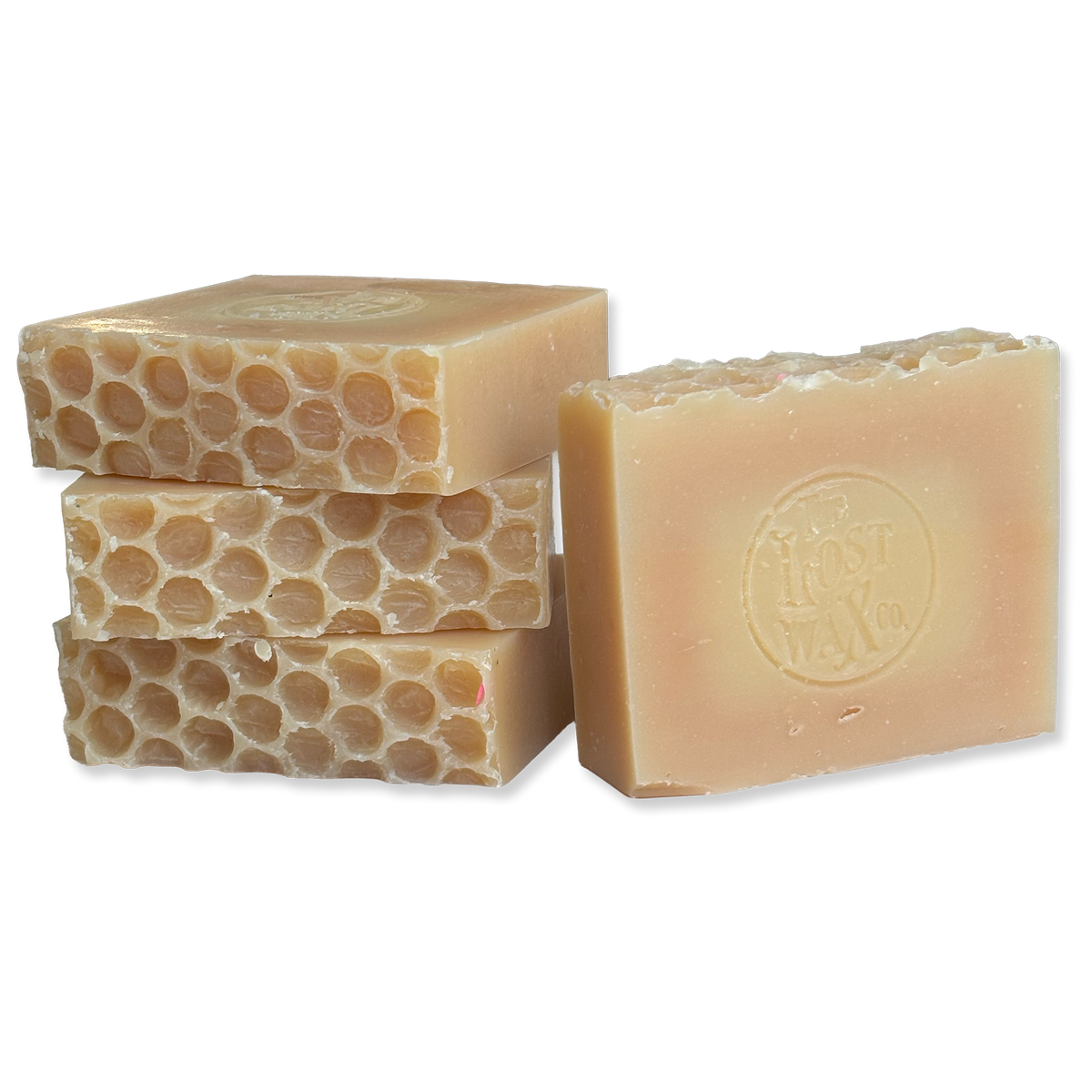 Four bars of pale amber handmade soap with the Lost Wax Co. brand.