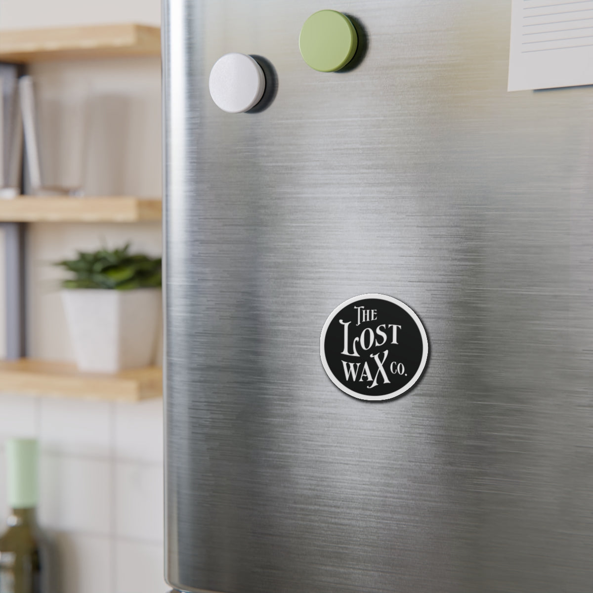 Metallic surface with a 'The Lost Wax Co.' logo magnet