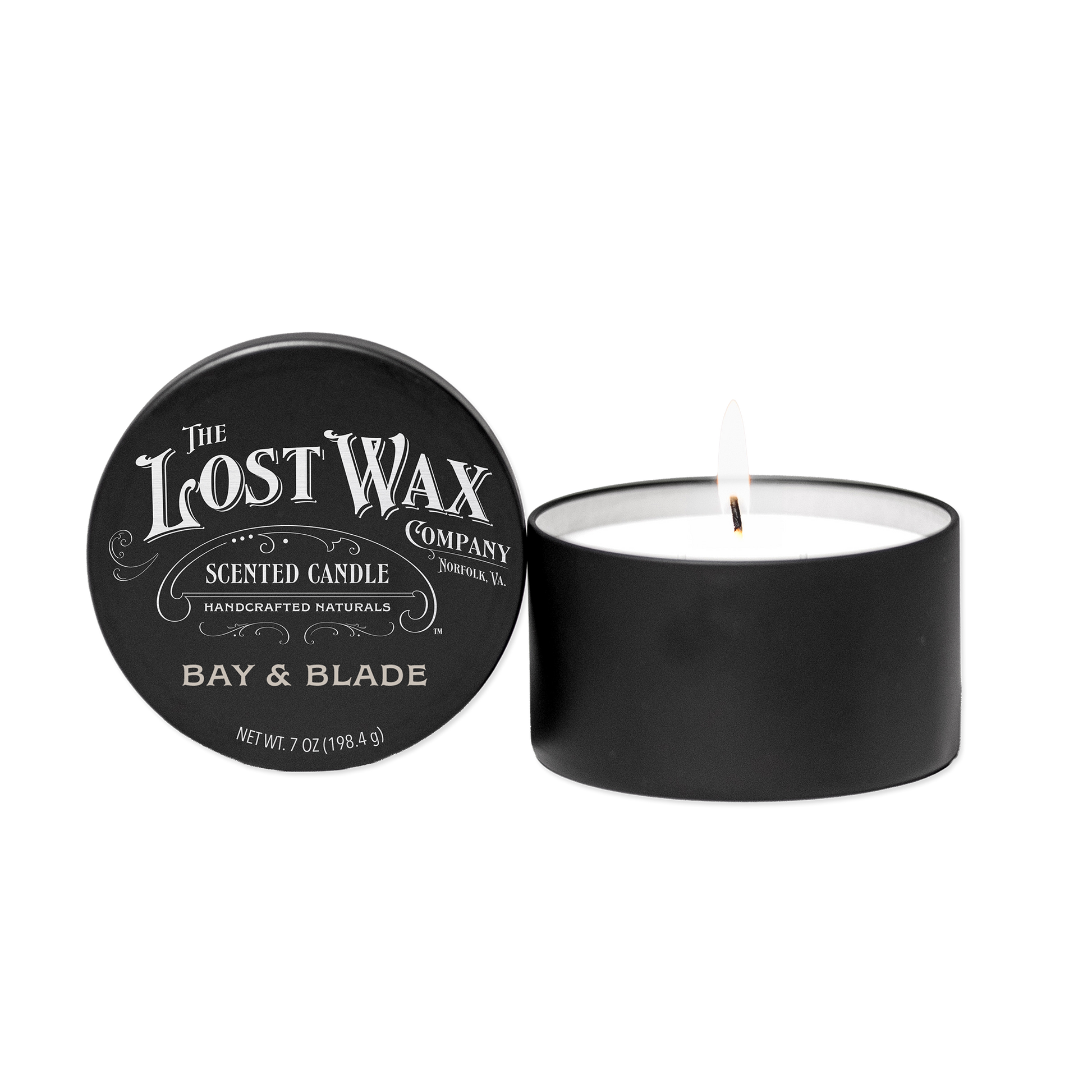 Scented candle with 'Bay & Blade' label and lid from 'The Lost Wax Company' on a white background