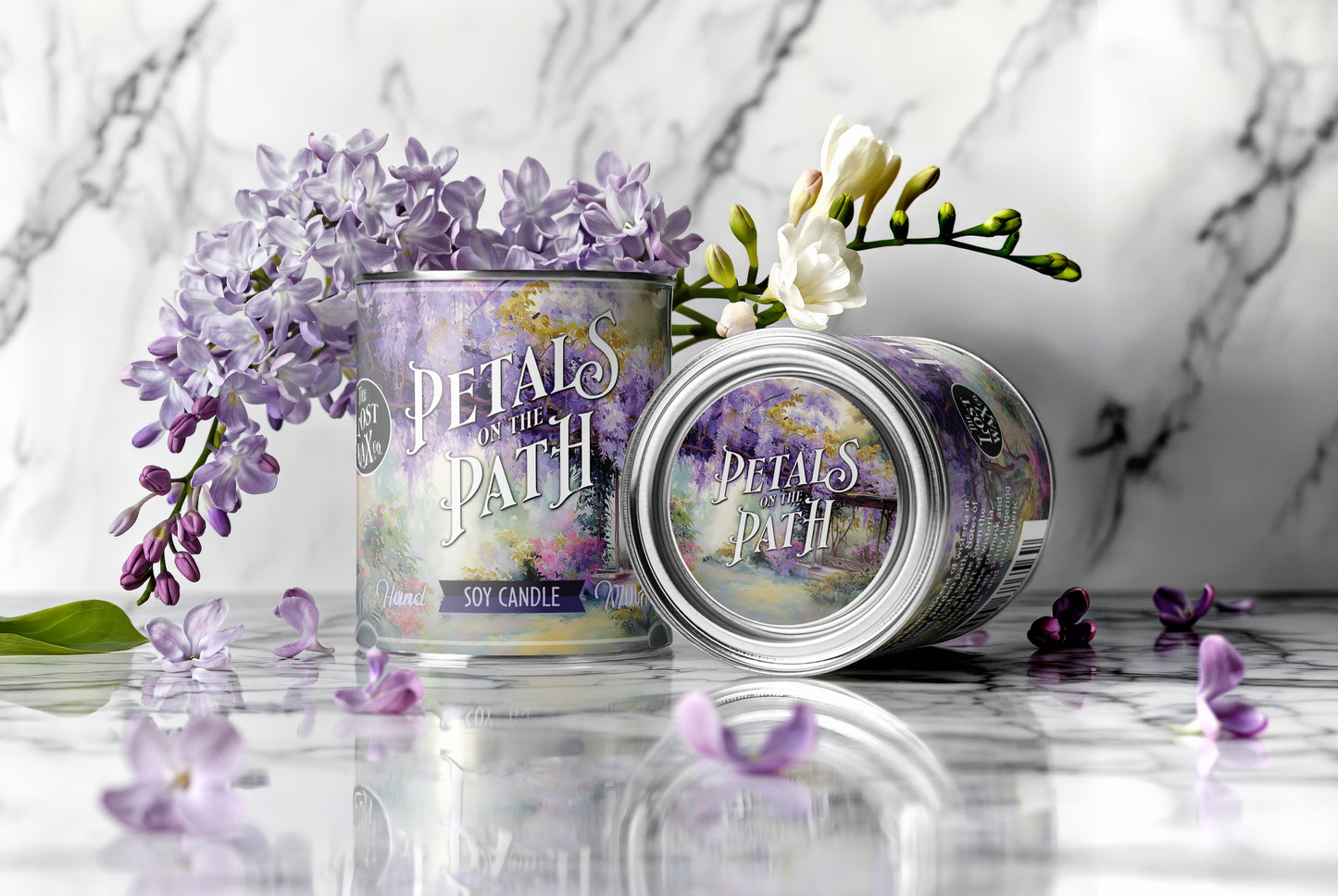 Two 'Petal's on the Path' candles with flowers on a marble surface