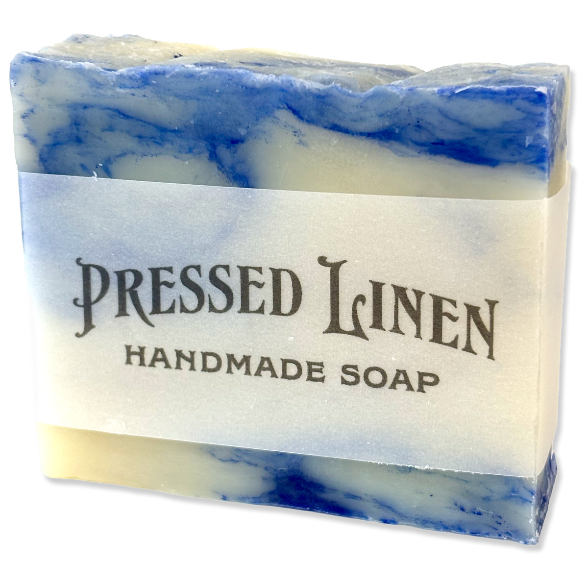 A rectangular bar of handmade soap with a white paper label reading 'PRESSED LINEN HANDMADE SOAP.' The soap has a marbled pattern of blue and cream, with blue bands visible near the top and bottom edges.