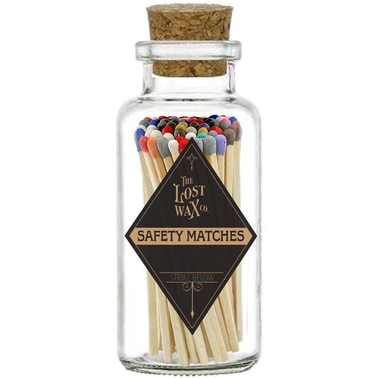 Glass jar with cork lid containing colorful safety matches from The Lost Wax Co.