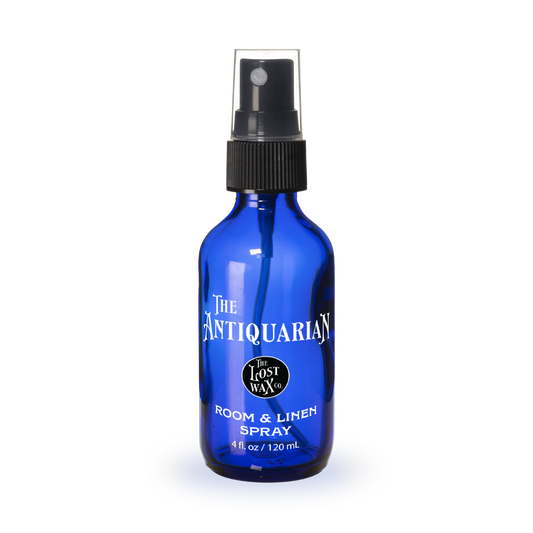 Blue spray bottle with a label on a white background