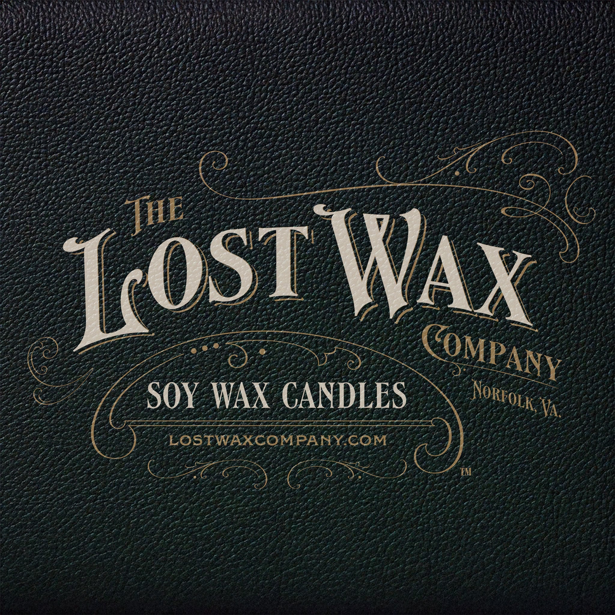 Logo of The Lost Wax Company on a dark leather textured background