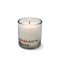 Candle in a glass holder with 'unicorn farts' text on a white background